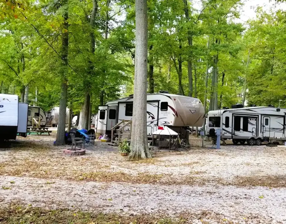 RV campers enjoying a shaded campsite at Woods-N-Waters Kampground in Columbus, Indiana