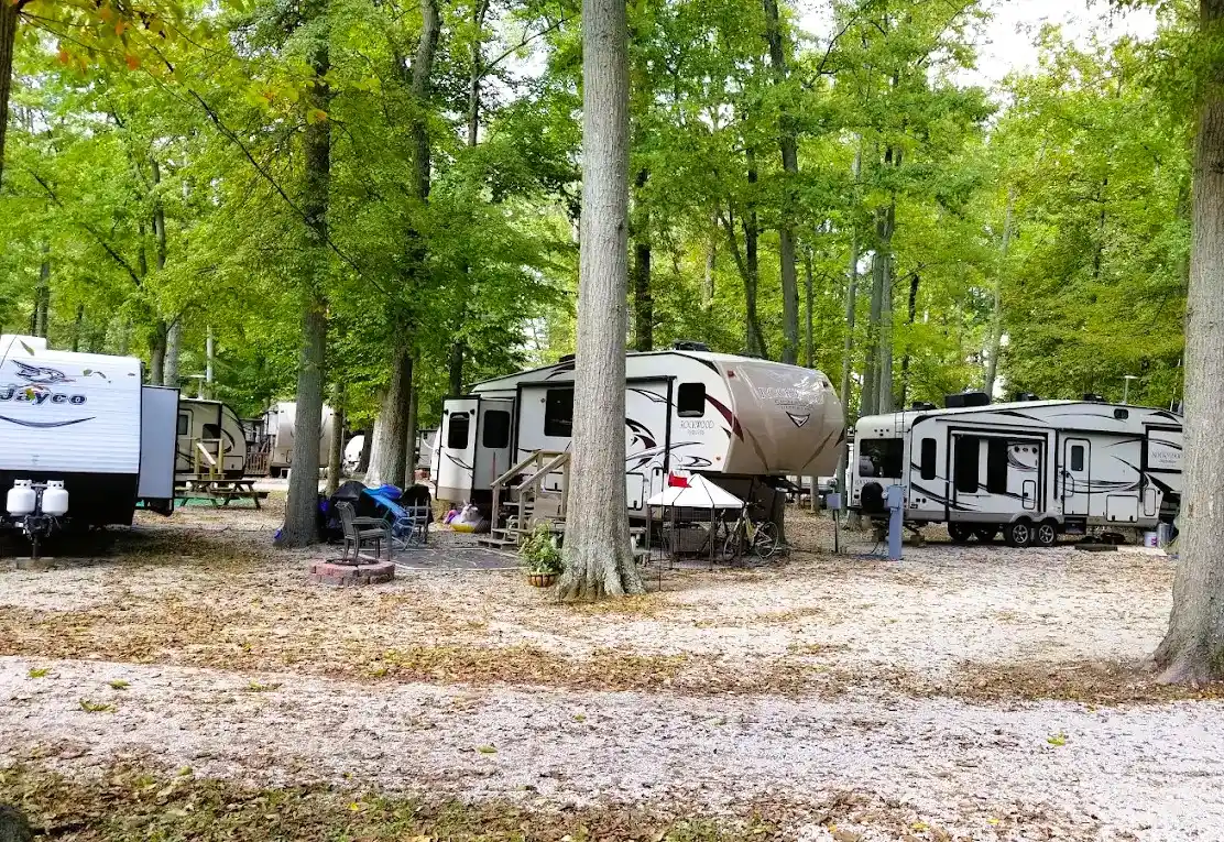 RV campers enjoying a shaded campsite at Woods-N-Waters Kampground in Columbus, Indiana